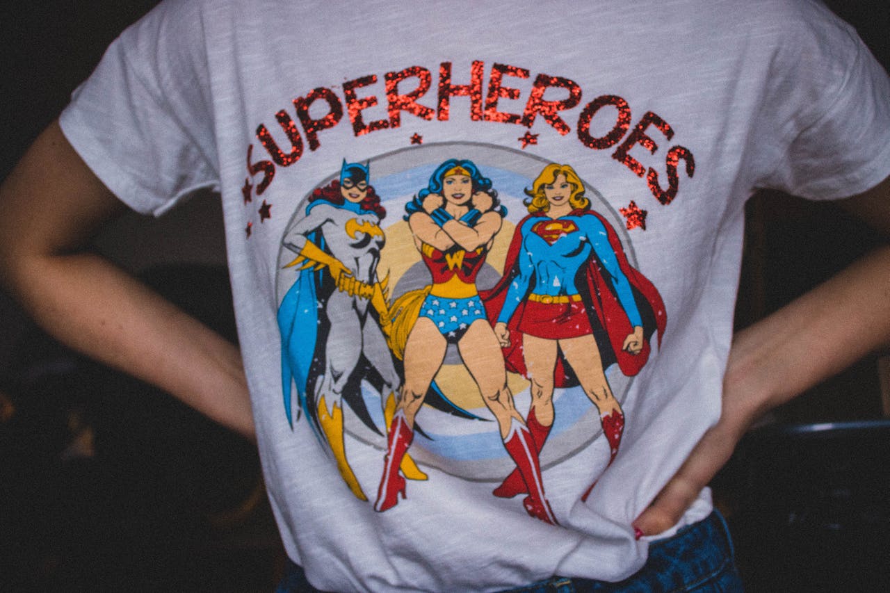A photo of a lady wearing a superhero t-shirt. 1) Batwomen 2) Wonder women 3) Supergirl